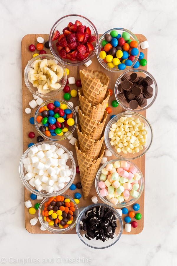 campfire cones board with waffle ice cream cones marshmallows and candies