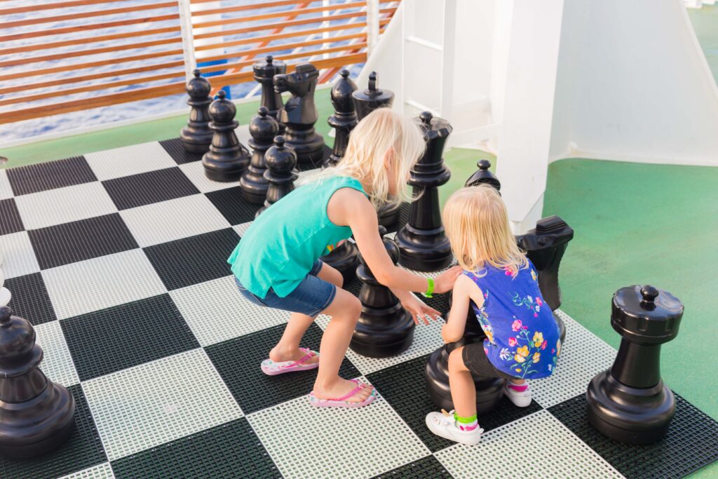 two girls playing jumbo chess on carnival horizon